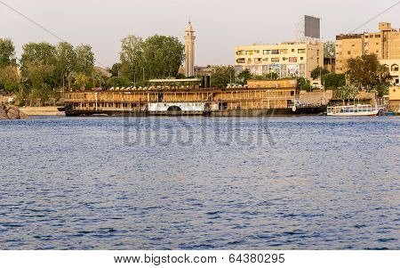 Nile River by Aswan City skyline with Boats