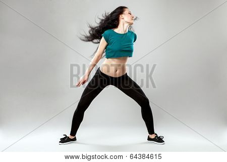 Professional dancer in studio on grey background