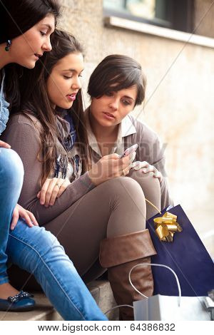 Happy Girls Messaging With Mobile Phone After Shopping