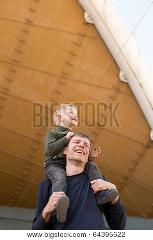 Father carrying his son on shoulders