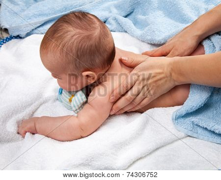 Masseuse massaging 5 months infant