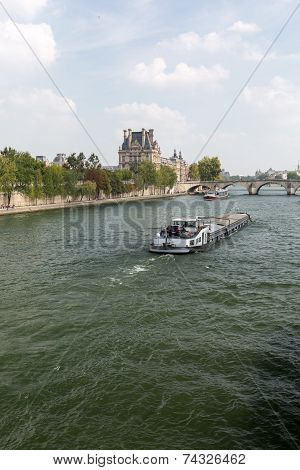 Paris - the barge swimming with Seine toward the Royal Bridge