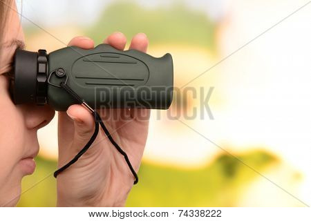 Modern monocular in hands on bright background