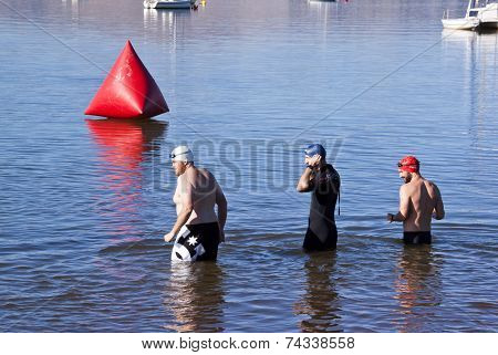 Three Swimmers Testing Water Before Swimming Race