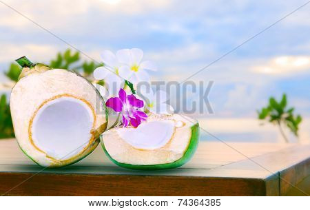 Twon Half Of Green Coconut Water On Top  Wood Table With Tropical Orchid Flowers And White  Frangipa