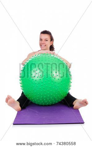 Young woman exercising with swiss ball