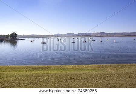 View From Grass Verge Of Yachts Moored On Dam