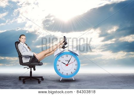 Woman in jacket and skirt sitting on chair. Background of the road with clouds, sun