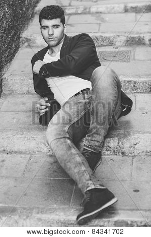 Handsome Young Man With Blue Eyes Posing Near A Wall