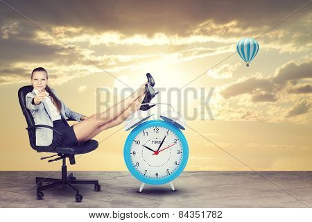 Woman in jacket, skirt sitting on chair. Evening sunset. Background of road with clouds, sun, hot ai
