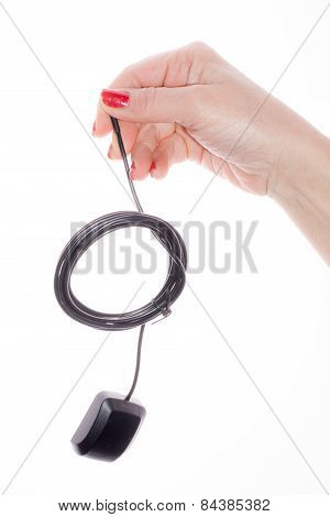 Hand holding GPS cable on a white background