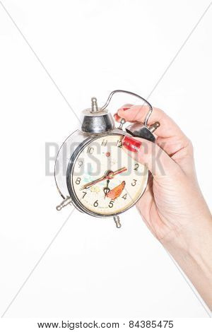 Hand holding a vintage clock over white background