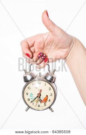 fingers holding retro watch over white background
