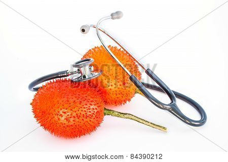 Gac Fruit And Stethoscope On White Background