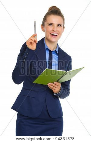 Businesswoman Holding Open Notebook And Pen Having Aha Moment