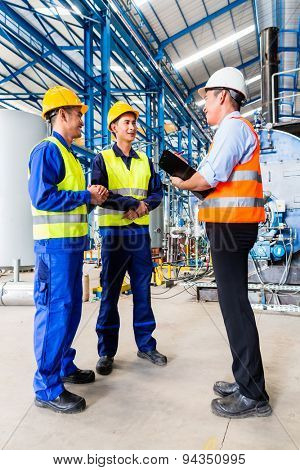 Asian factory worker and engineer as team inspecting a machine delivery