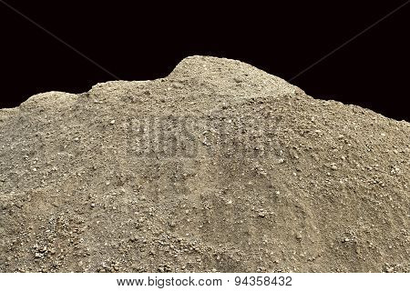 Pile of natural unsifted dirt with small pebbles and stones embedded - isolated on a black backgroun
