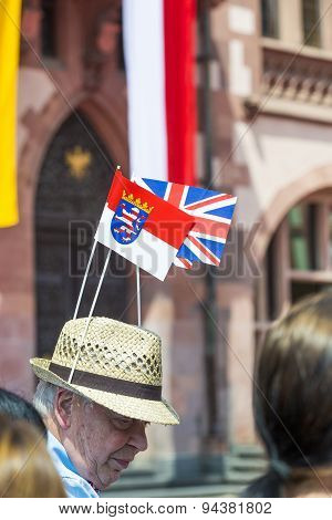 Man Waits For The Queen Elizabeth Ii With A Hat And British And Hesse Flag