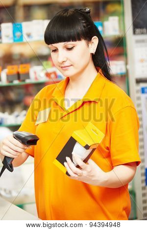 seller cashier with bar code scanner scanning lamp at store