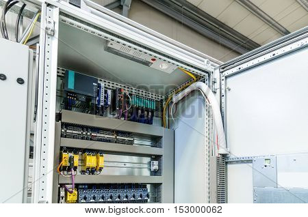 Automatic programming relay has control over electrical panel power lines located inside of the switch box.