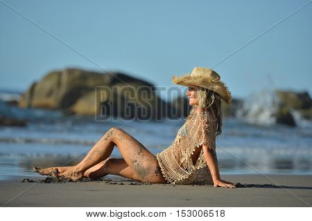 young woman relaxing on the beach in summer day