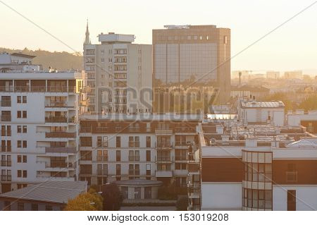 Krakow city architecture with sunset across horizon. Urban background. sunny haze