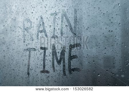 wording raintime on glass - raindrops on window