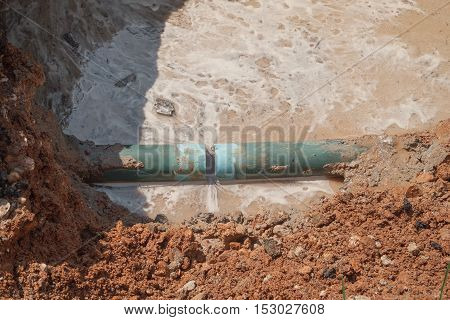 repair the plumbing broken pipe and water flow in hole.