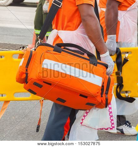 physician readiness box bag first aid kit and yellow stretcher medical equipment. assist patient in emergency rescue situations.(select focus first aid kit and soft-focus background)