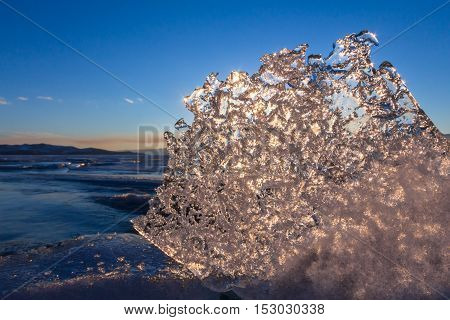 Sun At Sunset Shining Through The Transparent Texture Of The Ice Floe In Lake Baikal