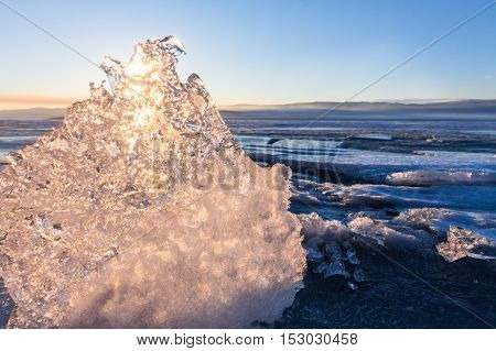 Sun At Sunset Shining Through The Transparent Texture Of The Ice Floe In Lake Baikal