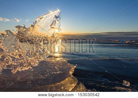 Sun At Sunset Shining Through The Transparent Texture Of The Ice Floe In Lake Baikal