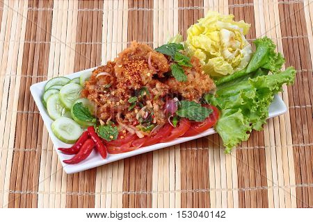 Home made,Spicy fried chicken salad (Yum Kai Zap in Thai)  topped cucumber,red chili,lettuce and cabbage.