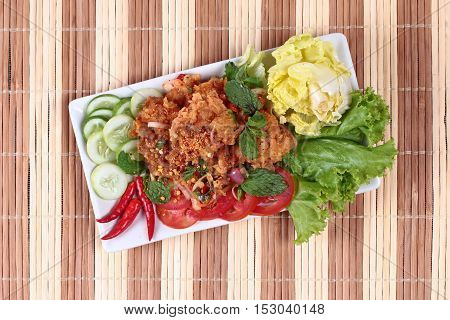 Home made,Spicy fried chicken salad (Yum Kai Zap in Thai)  topped cucumber,red chili,lettuce and cabbage.
