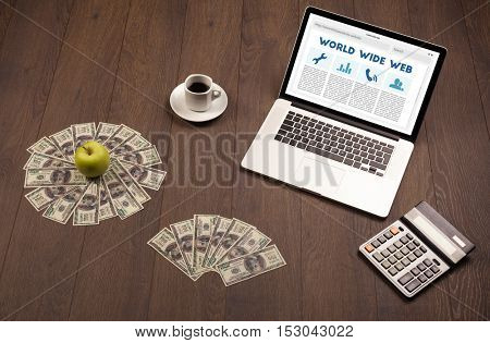Laptop computer on wooden desk with office suplies