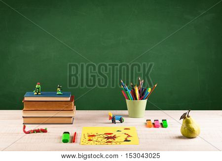 Back to school concepty with clear blackboard background, desk, items