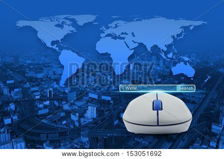 Wireless computer mouse with search www button over city tower street and expressway Searching system and internet concept Elements of this image furnished by NASA