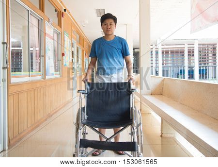 Empty wheelchair parked in hospital with selective focus.