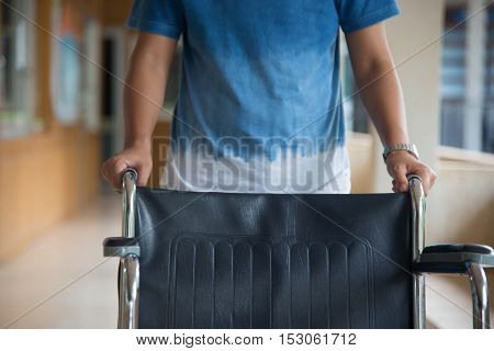 Empty Wheelchair Parked In Hospital