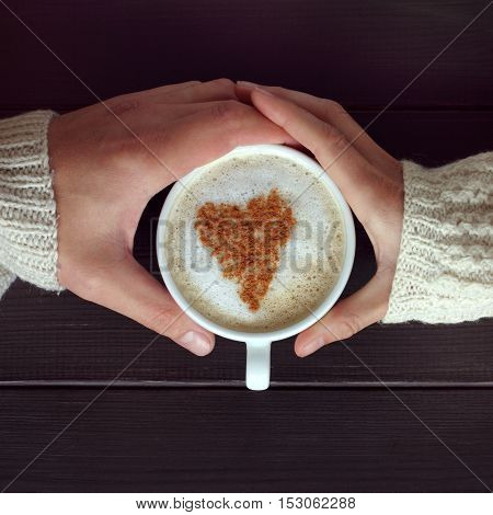 couple people transmitting cappuccino with a heart to each other / recognition ardent love