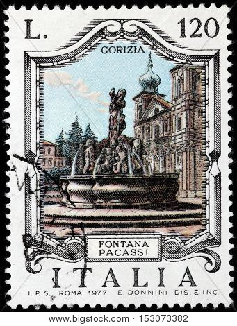 LUGA RUSSIA - JUNE 25 2016: A stamp printed by ITALY shows view of The Victory Square (Piazza della Vittoria) with famous Pacassi Fountain (Fontana Pacassi) in Gorizia Italy circa 1977
