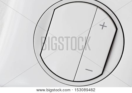 front view of plastic white dimmer light switch closeup