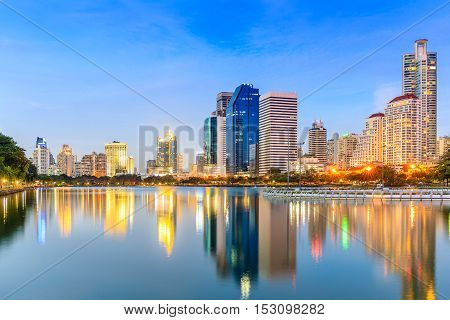 Modern buildings in office district at twilight in Bangkok Thailand with blue sky.