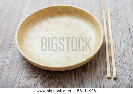 Yellow Green Plate And Chopsticks On Gray