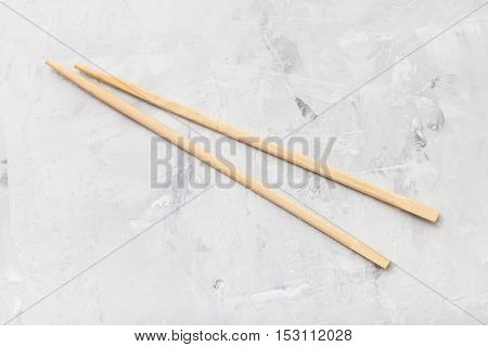 Wooden Disposable Chopsticks On Concrete Board