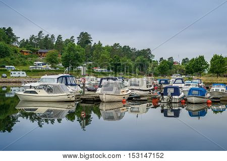 Small recreational motor boats at Falkensten village camping. Norway.