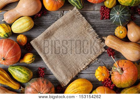 Autumn pumpkin harvest decoration frame empty blank space for design text with cloth Thanksgiving dinner or Halloween setting on vintage wooden background wallpapper