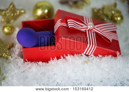 Dildo as a Christmas present, with Christmas tree balls and snow