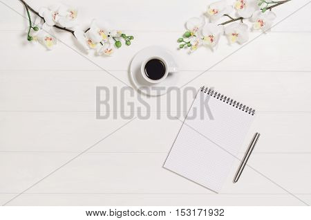 Feminine, elegant woman's white, wooden table, desk or workspace seen from above. Top view background with copy space. Creative workspace for freelance girl working from home