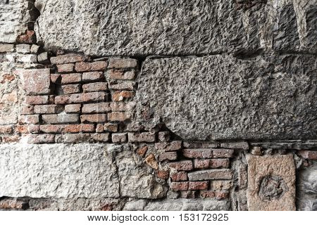 Pattern of stone wall structure with various foundation stone and brick. Old wall European home.